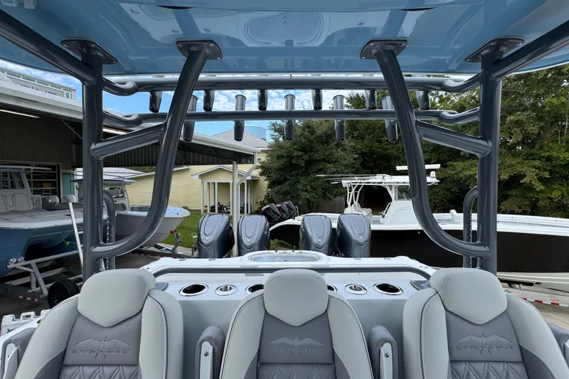 Slide: The Image of 2026 Invincible 38 Catamaran interior with seating and multiple outboard engines. - 30