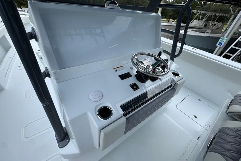 Slide: The Image of 2026 Invincible 38 Catamaran helm with steering wheel and control panel. - 31