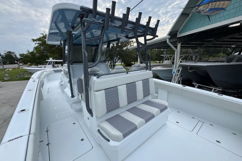 Slide: The Image of 2026 Invincible 38 Catamaran with sleek seating and modern design in a marina setting. - 36