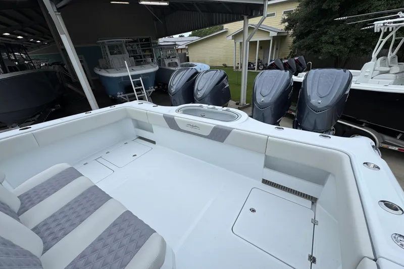 Slide: The Image of 2026 Invincible 38 Catamaran with spacious deck and multiple outboard engines in a covered area. - 39