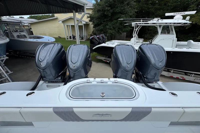 Slide: The Image of 2026 Invincible 38 Catamaran with four powerful outboard engines, docked in a marina. - 40