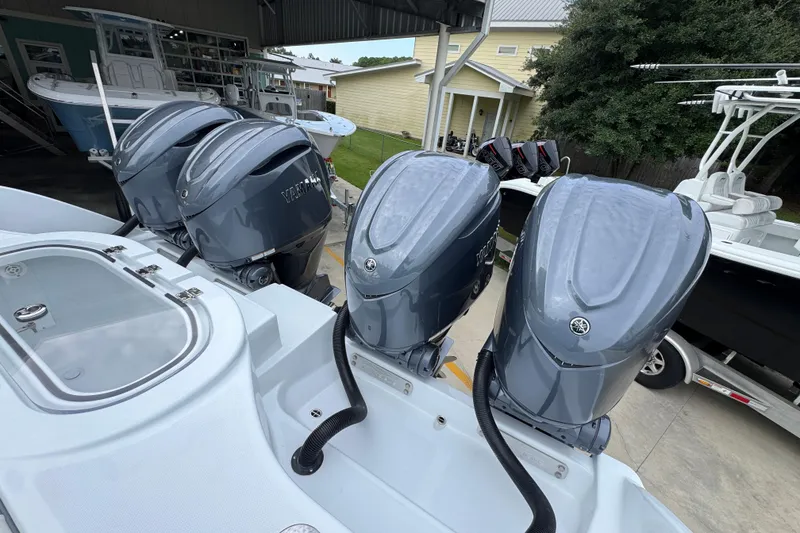 Slide: The Image of 2026 Invincible 38 Catamaran with four Yamaha outboard engines, docked under a shelter. - 41