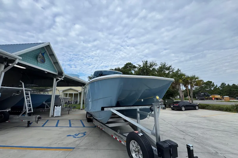 Slide: The Image of 2026 Invincible 38 Catamaran on trailer at marina under cloudy sky. - 7