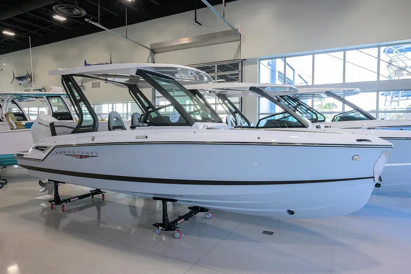 The Image of 2026 Monterey Elite 25 OB boat displayed in a showroom. - 0