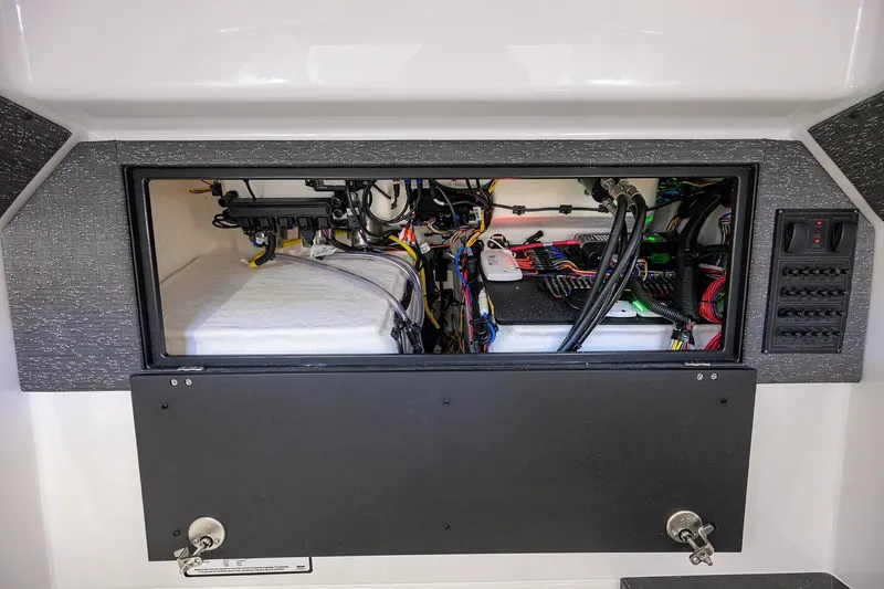 Slide: The Image of Electrical compartment of 2026 Monterey Elite 25 OB boat, showcasing wiring and components. - 12