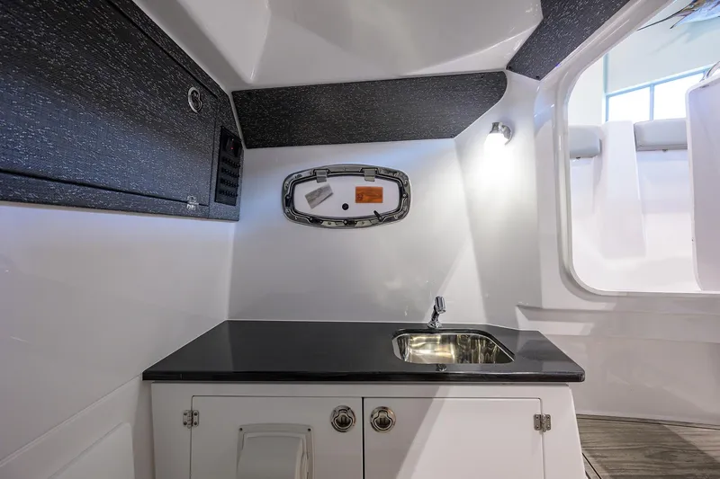 Slide: The Image of Interior of 2026 Monterey Elite 25 OB boat featuring a sleek sink and modern design. - 14