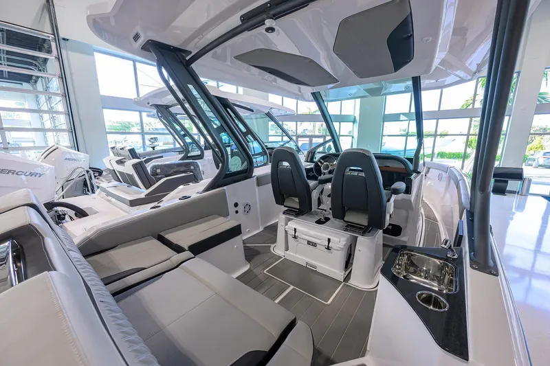 Slide: The Image of 2026 Monterey Elite 25 OB boat interior with modern seating and controls. - 16