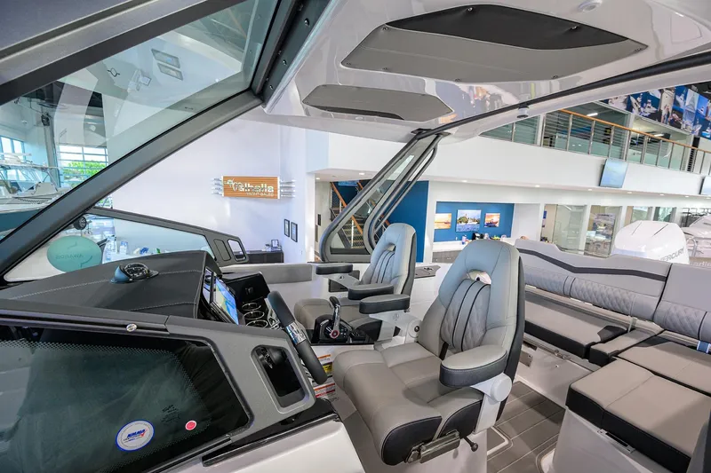 Slide: The Image of 2026 Monterey Elite 25 OB boat interior with modern seating and dashboard. - 20