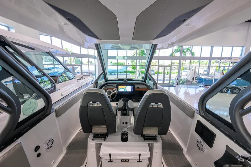 Slide: The Image of Interior view of 2026 Monterey Elite 25 OB boat, featuring modern helm and seating. - 22