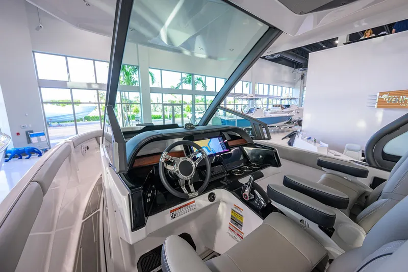 Slide: The Image of Interior view of 2026 Monterey Elite 25 OB boat with modern dashboard and seating. - 23