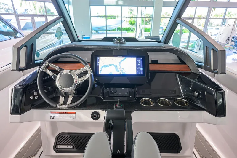 Slide: The Image of 2026 Monterey Elite 25 OB boat dashboard with modern steering and navigation display. - 24
