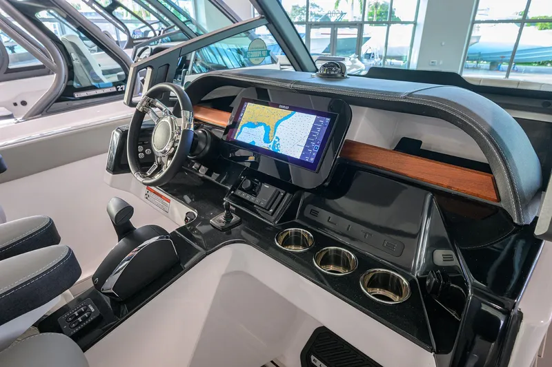 Slide: The Image of 2026 Monterey Elite 25 OB boat dashboard with navigation screen and steering wheel. - 25