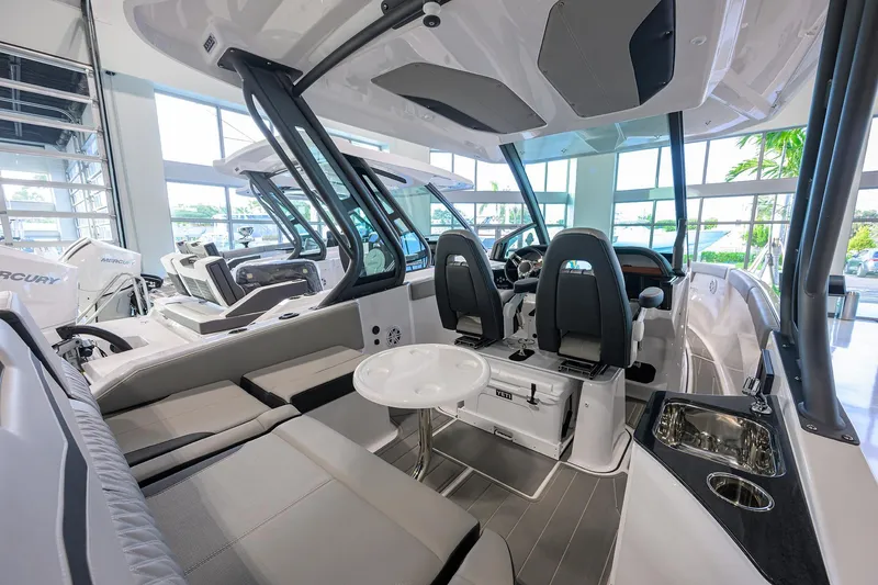 Slide: The Image of 2026 Monterey Elite 25 OB boat interior with seating, helm, and modern amenities. - 31