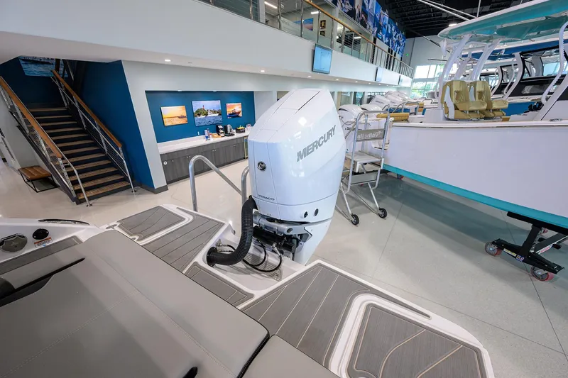 Slide: The Image of 2026 Monterey Elite 25 OB boat with Mercury outboard engine in showroom. - 33