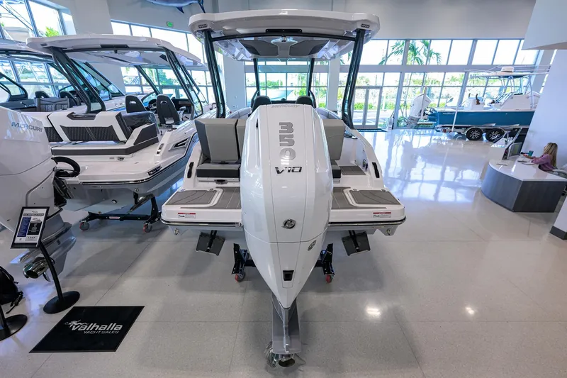 Slide: The Image of 2026 Monterey Elite 25 OB boat with powerful V10 engine displayed in showroom. - 34