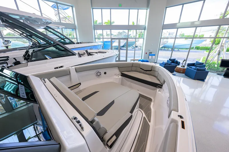 Slide: The Image of 2026 Monterey Elite 25 OB boat interior in a showroom with modern seating. - 5