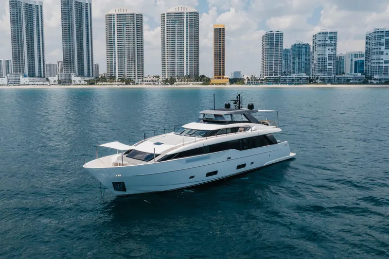 Slide: The Image of 2024 Sanlorenzo SL90A yacht cruising near a city skyline on a sunny day. - 12