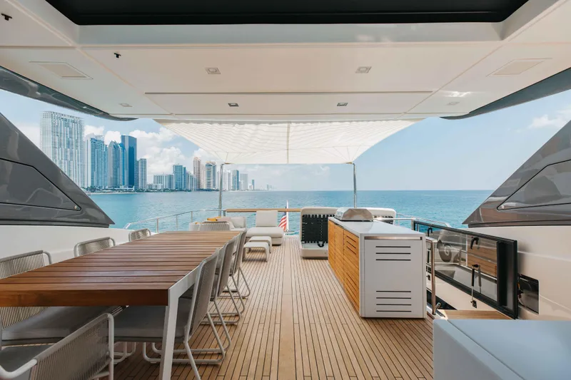 Slide: The Image of Luxurious 2024 Sanlorenzo SL90A yacht deck with ocean view and city skyline. - 63