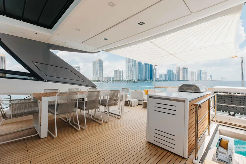 Slide: The Image of Luxurious 2024 Sanlorenzo SL90A yacht deck with dining area, city skyline view. - 64