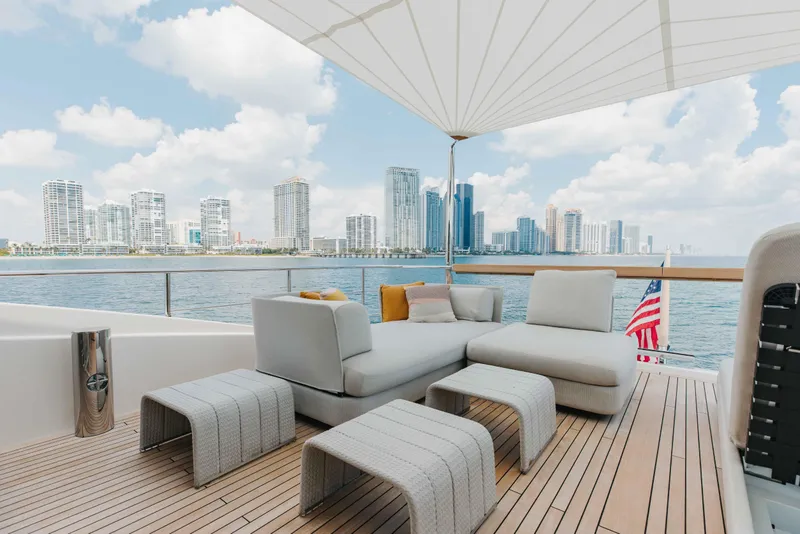 Slide: The Image of Luxurious 2024 Sanlorenzo SL90A yacht deck with modern seating, city skyline view. - 65