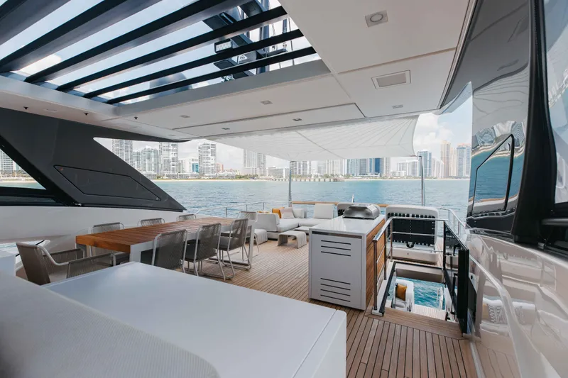 Slide: The Image of Luxurious 2024 Sanlorenzo SL90A yacht deck with modern seating and city skyline view. - 77