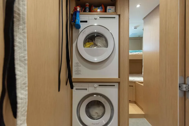 Slide: The Image of Laundry area with stacked washer and dryer in 2024 Sanlorenzo SL90A yacht. - 86