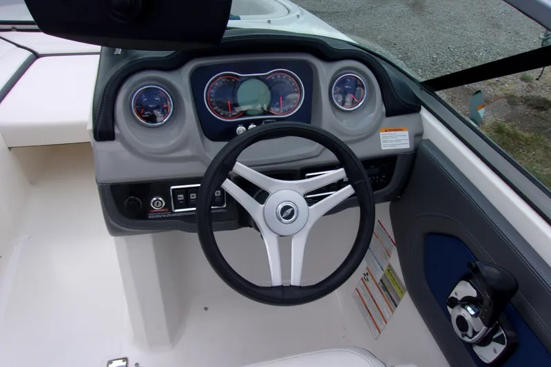 Slide: The Image of 2016 Chaparral Vortex 203 VR boat dashboard with steering wheel and gauges. - 6