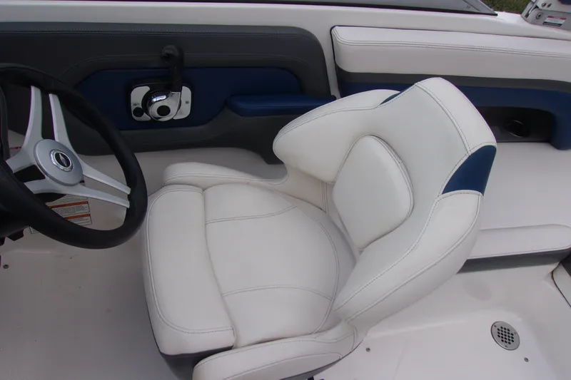 Slide: The Image of 2016 Chaparral Vortex 203 VR boat interior with white captain's seat and steering wheel. - 7