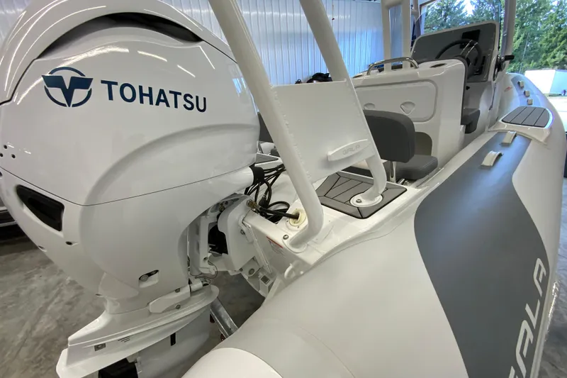 Slide: The Image of 2026 Gala V500 boat with Tohatsu outboard motor in a showroom. - 13