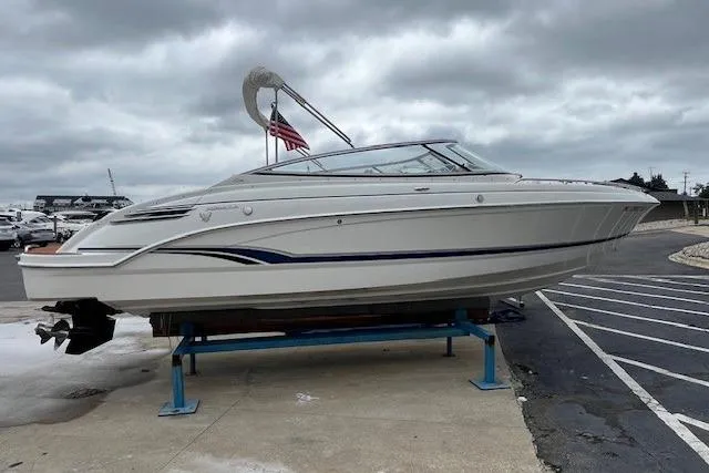 The Image of 2006 Formula 240 Bowrider boat on display, overcast sky, American flag in background. - 0