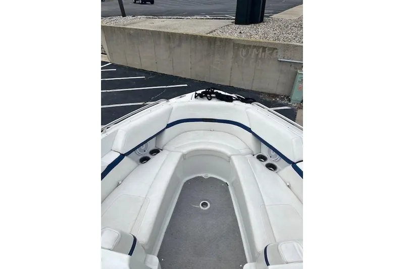 Slide: The Image of 2006 Formula 240 Bowrider boat interior with white seating and cup holders. - 11