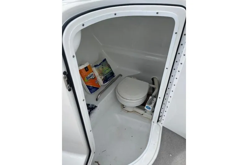 Slide: The Image of 2006 Formula 240 Bowrider boat toilet compartment with supplies. - 14