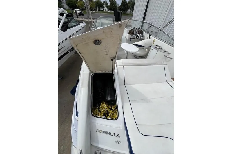 Slide: The Image of 2006 Formula 240 Bowrider boat with open storage compartment and seating area. - 15