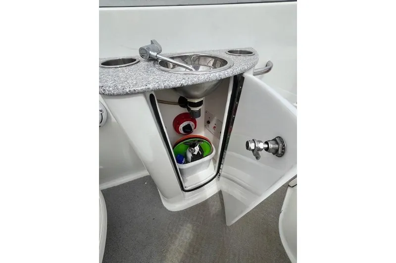 Slide: The Image of 2006 Formula 240 Bowrider boat sink with storage cabinet and faucet. - 17