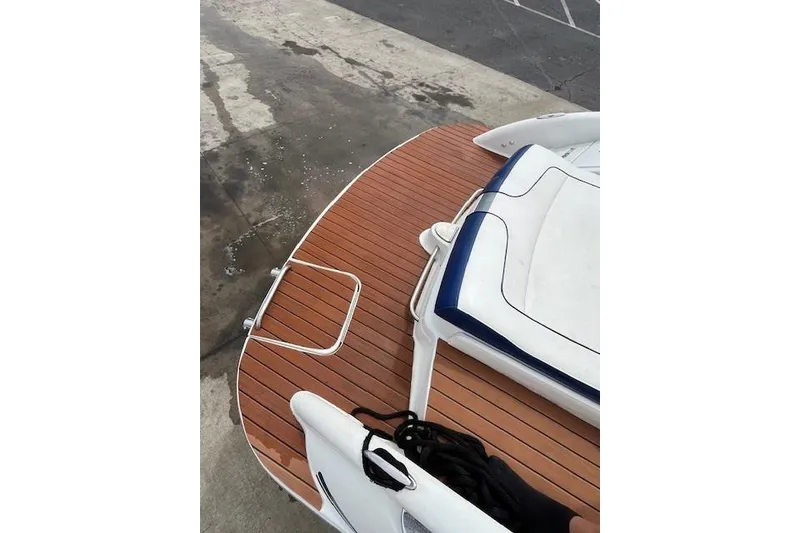 Slide: The Image of 2006 Formula 240 Bowrider boat with teak deck and white seating. - 18