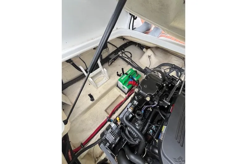 Slide: The Image of Engine compartment of a 2006 Formula 240 Bowrider with visible battery and components. - 21