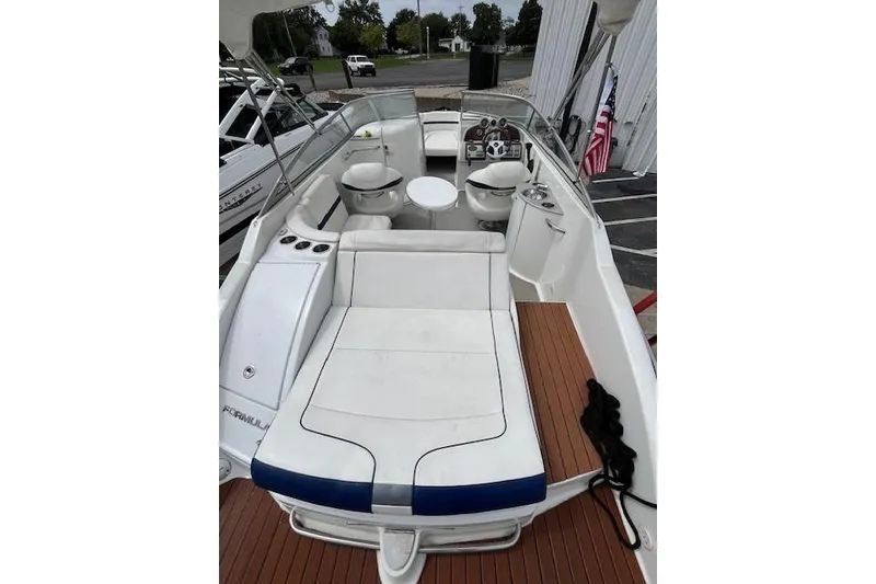 Slide: The Image of 2006 Formula 240 Bowrider boat interior with white seating and wooden deck. - 3