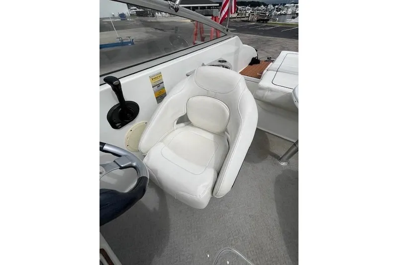 Slide: The Image of 2006 Formula 240 Bowrider cockpit with white cushioned seat and steering wheel. - 9
