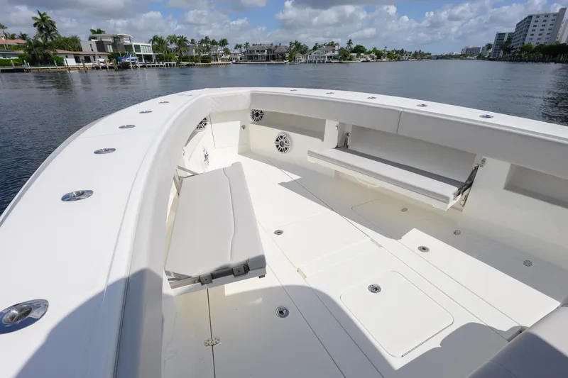 Slide: The Image of 2021 SeaVee 390Z boat deck with seating, cruising on a scenic waterway. - 11