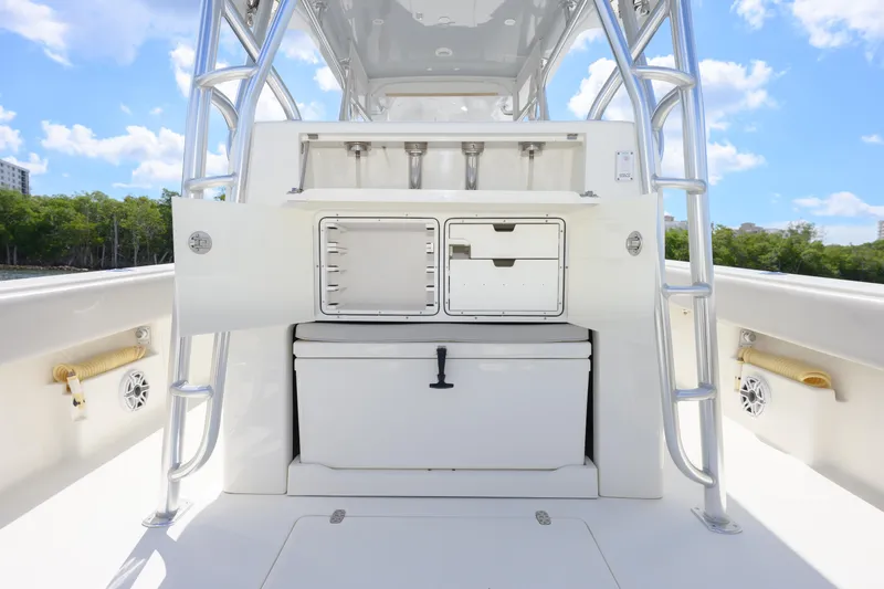 Slide: The Image of 2021 SeaVee 390Z boat interior with storage compartments and ladder, under a clear blue sky. - 12