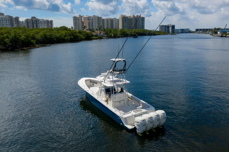 Slide: The Image of 2021 SeaVee 390Z boat cruising on a scenic waterway with city skyline. - 3