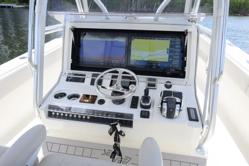 Slide: The Image of 2021 SeaVee 390Z boat console with dual navigation screens and steering wheel. - 4
