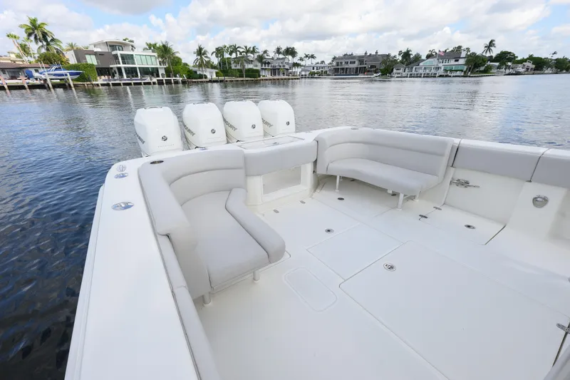 Slide: The Image of 2021 SeaVee 390Z boat with spacious seating and multiple outboard engines on a calm waterfront. - 6