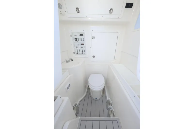 Slide: The Image of 2021 SeaVee 390Z boat interior bathroom with toilet and control panel. - 8