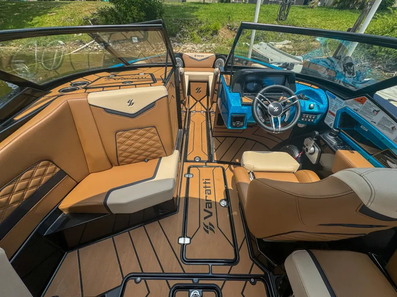 Slide: The Image of 2024 Varatti Z2373 boat interior with tan and black seating, modern dashboard, and spacious layout. - 10