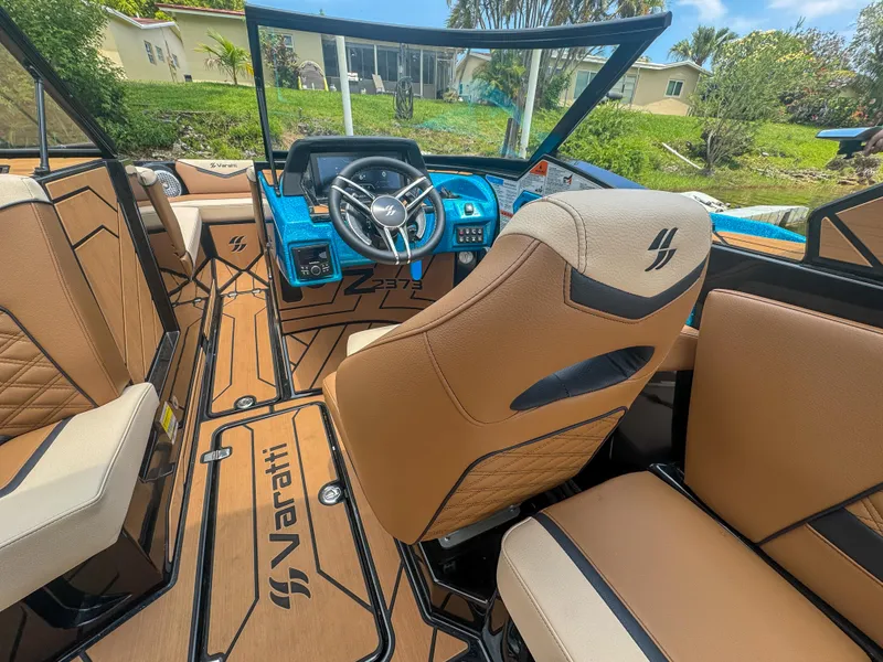 Slide: The Image of 2024 Varatti Z2373 boat interior with tan seats and modern dashboard. - 11