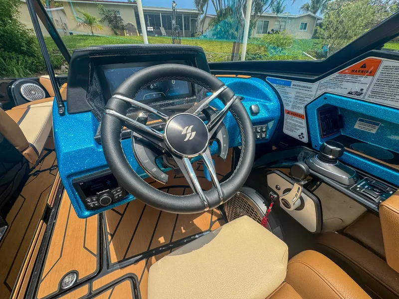 Slide: The Image of 2024 Varatti Z2373 boat dashboard with steering wheel and control panel. - 12