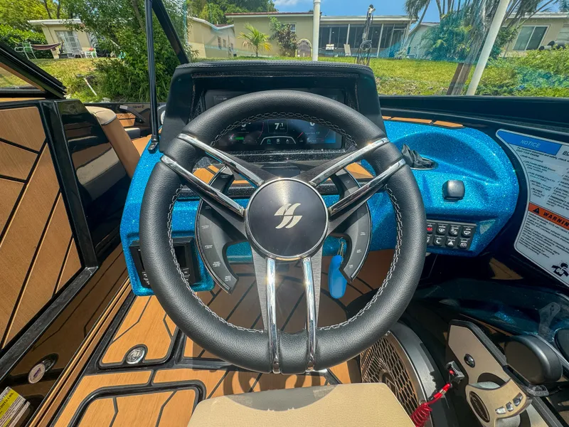 Slide: The Image of 2024 Varatti Z2373 boat steering wheel and dashboard in a sunny outdoor setting. - 13