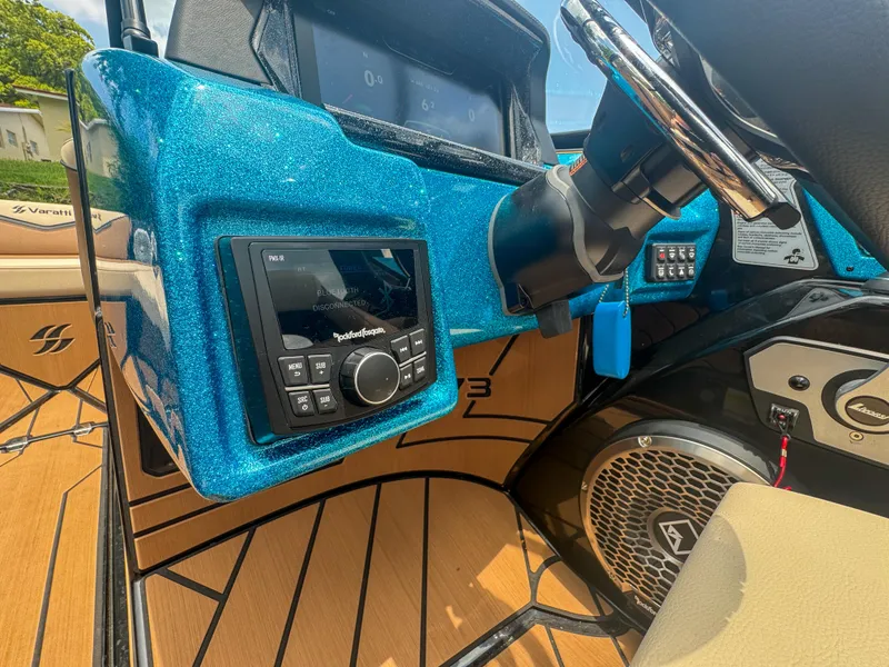 Slide: The Image of 2024 Varatti Z2373 boat dashboard with Rockford Fosgate audio system and steering wheel. - 17