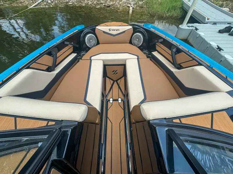 Slide: The Image of 2024 Varatti Z2373 boat interior with tan and black seating, docked by the water. - 21